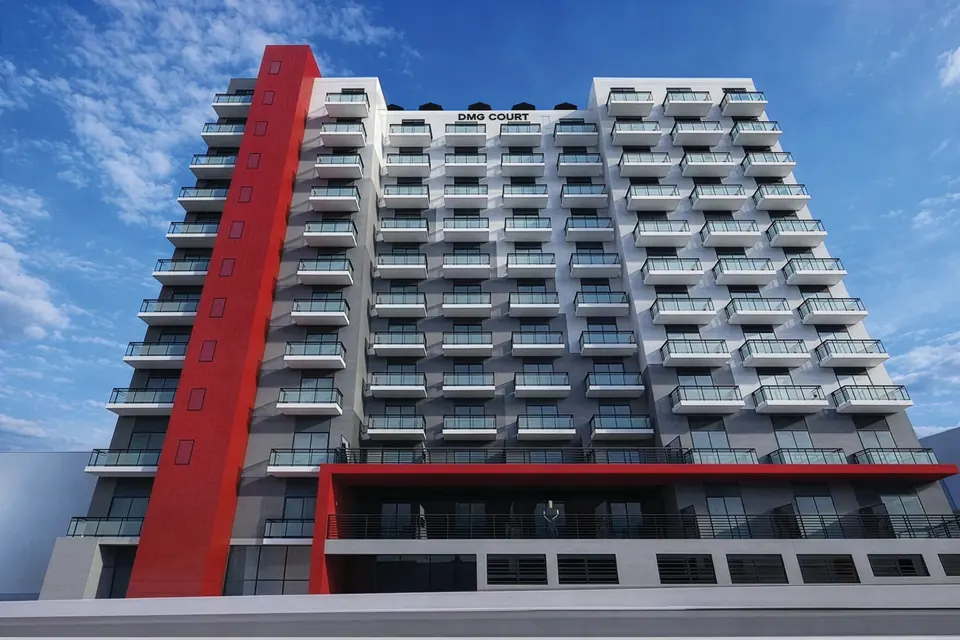 Mid-rise apartment building in red and white cladding
