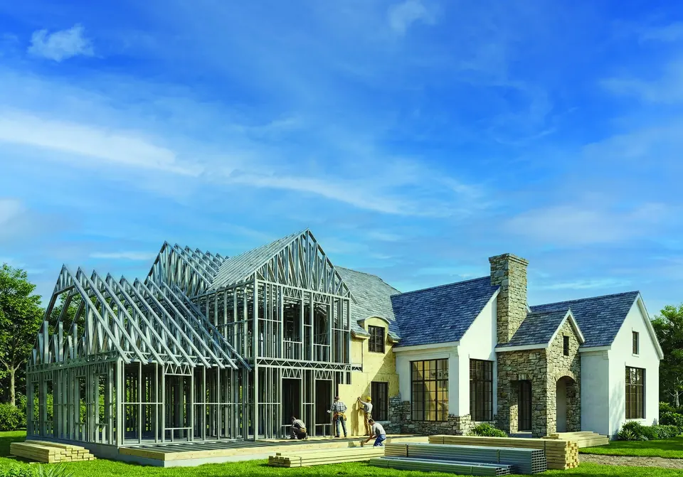 Single family house being framed in cold formed steel beside a completed home